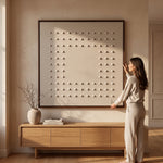 Cargar imagen en el visor de la Galería, Mujer junto al Cuadro Decorativo Retícula I Técnica Mixta con Marco Nogal sobre un mueble de madera.